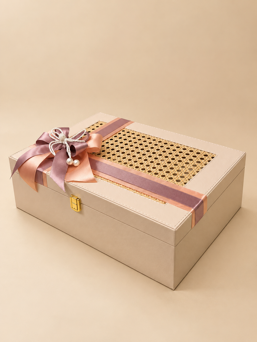 Cream cane-weave keepsake Diwali gift box with satin bow and festive treats, by Demould Delhi