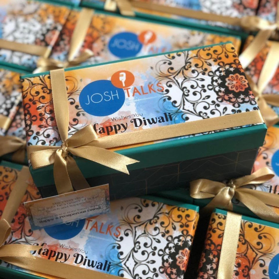 Personalised Diwali hamper for employees with branded sleeve and gold ribbon