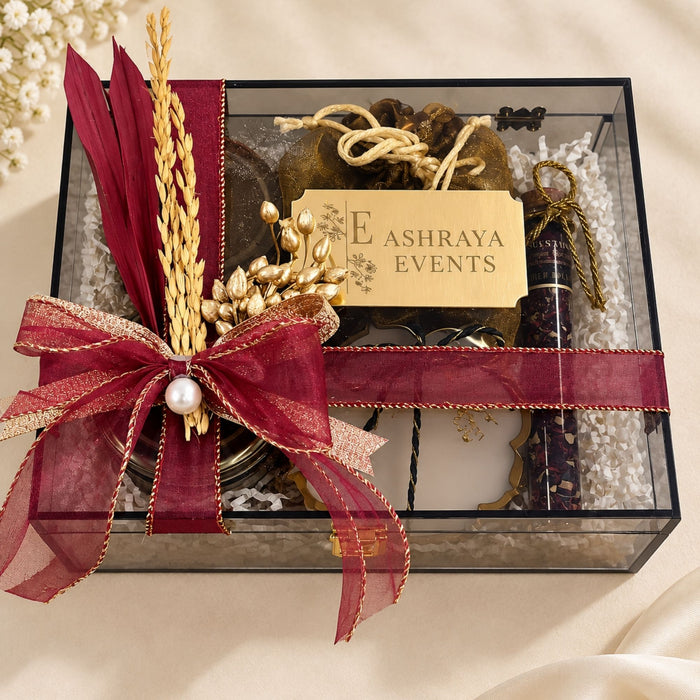 Clear acrylic Diwali hamper with personalised name plaque and maroon bow, customised by Demould Delhi