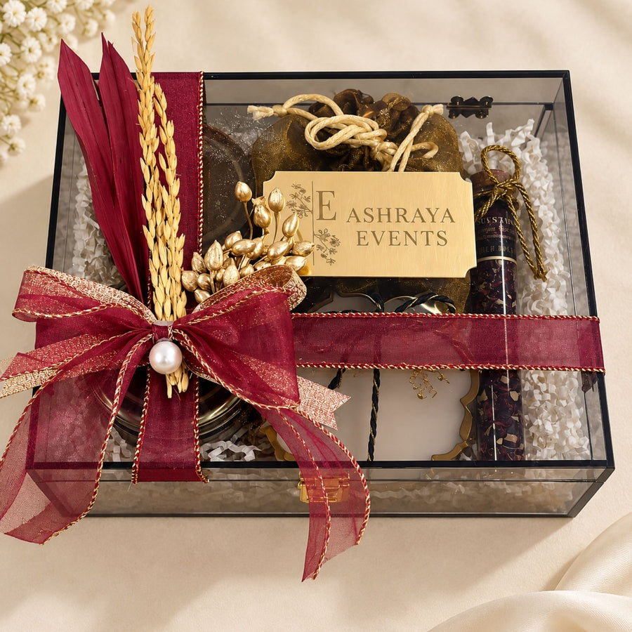 Clear acrylic Diwali hamper with personalised name plaque and maroon bow, customised by Demould Delhi