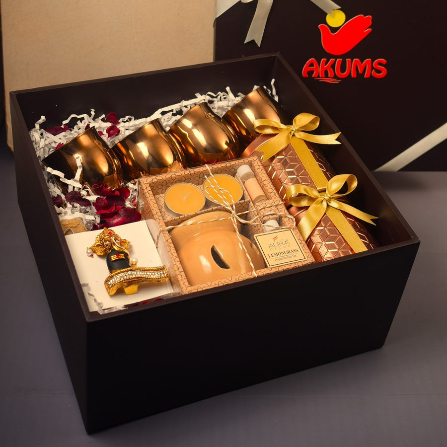 Diwali gift boxes with custom printed sleeves and gold ribbon in company colours for employees, by Demould