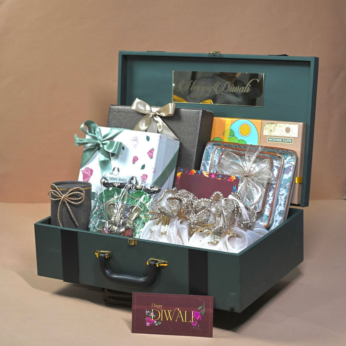 Green suitcase-style premium Diwali hamper with gourmet treats and chocolates for key clients, by Demould