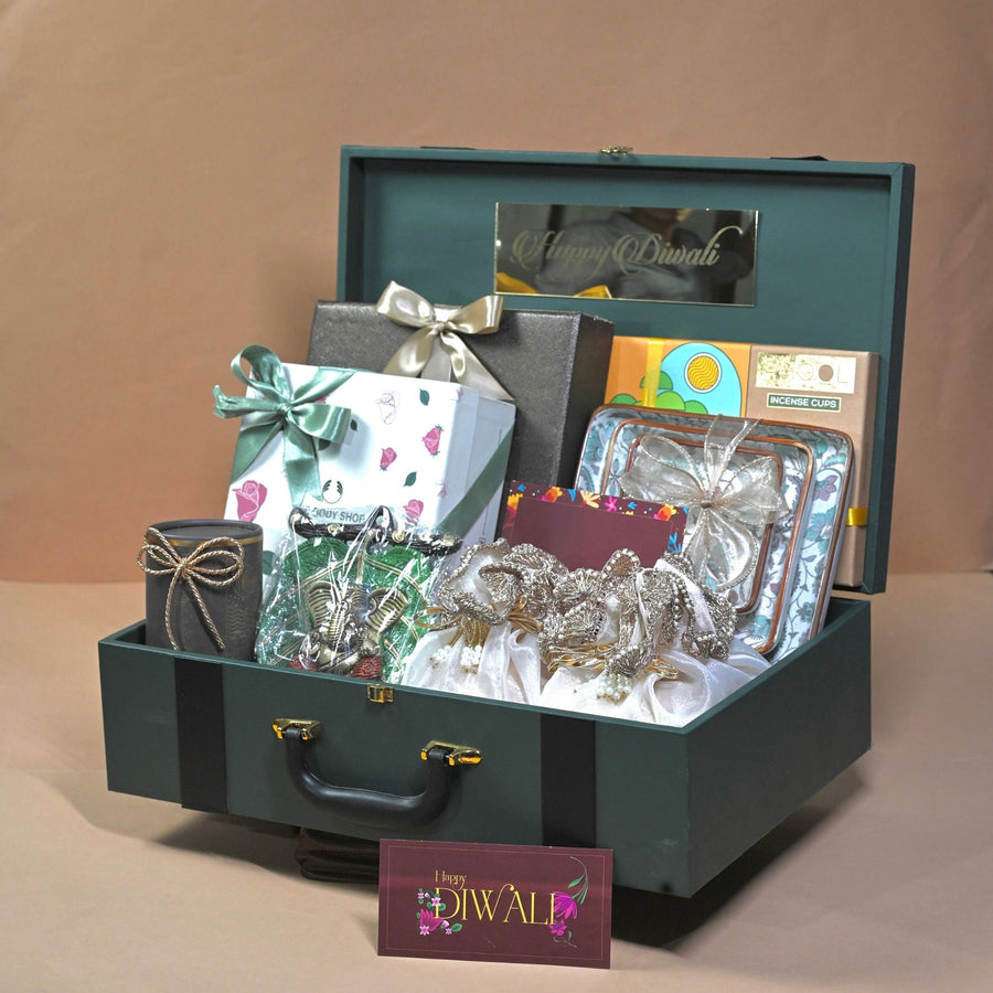 Green suitcase-style premium Diwali hamper with gourmet treats and chocolates for key clients, by Demould
