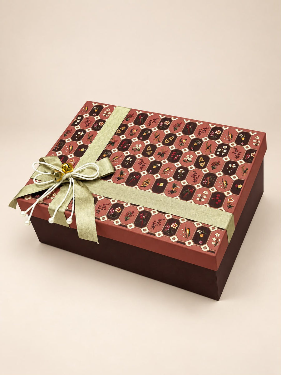 Black octagonal cane-weave Diwali hamper box with copper tumblers and gold potlis, by Demould Delhi