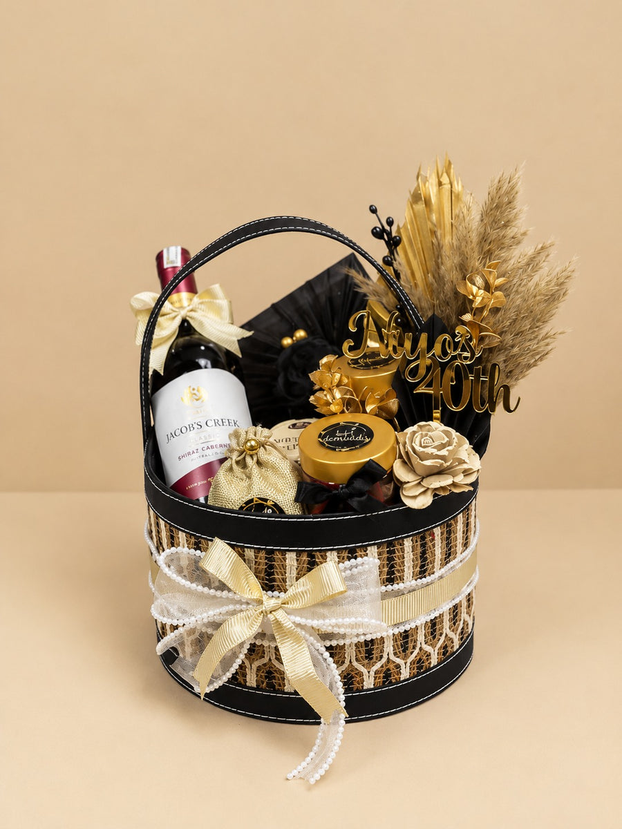 Luxury Diwali gift basket with a premium bottle, gourmet treats and gold accents for corporate clients, by Demould Delhi