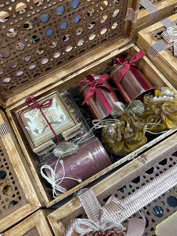 Carved jaali wooden Diwali hamper with copper bottles, potli bags and sweets for clients, by Demould Delhi