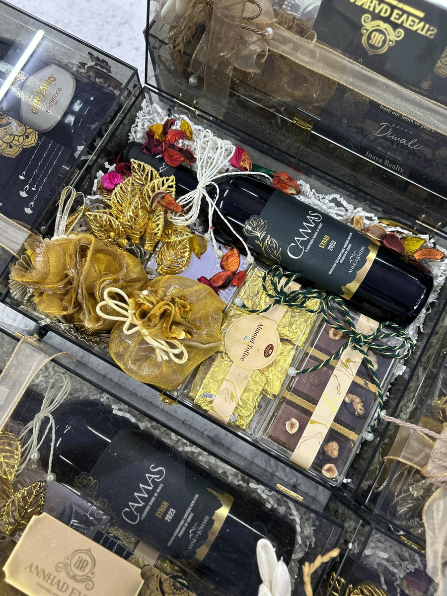 Clear acrylic luxury Diwali hampers with gold potlis and chocolates, packed in bulk for corporates by Demould