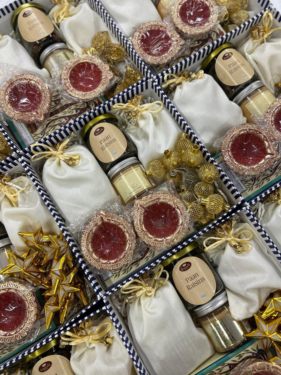 Black and gold Diwali gift boxes with copper tins and personalised cards for bulk employee gifting, by Demould